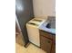 Close-up of laundry machine next to counter and sink at 10800 N Us Highway 19 # 237, Pinellas Park, FL 33782