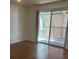 Bright living room featuring light wood floors, neutral walls, and sliding glass doors to screened-in porch at 10800 N Us Highway 19 # 237, Pinellas Park, FL 33782