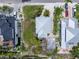 An aerial view of a single-Gathering home with a metal roof, surrounded by lush landscaping and other homes at 109 Maple Ave, Anna Maria, FL 34216