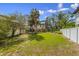 Expansive backyard featuring a well-maintained lawn, mature trees, and potential for outdoor activities at 109 Maple Ave, Anna Maria, FL 34216