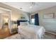 Serene bedroom with a stylish blue headboard, soft bedding, and an inviting, tranquil atmosphere at 109 Maple Ave, Anna Maria, FL 34216