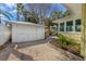 Exterior shot of the garage and backyard, showcasing the home's curb appeal and outdoor space at 109 Maple Ave, Anna Maria, FL 34216