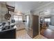 Well-lit kitchen featuring stainless steel appliances, bright cabinetry, and retro-inspired flooring at 109 Maple Ave, Anna Maria, FL 34216