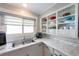 Bright kitchen featuring updated countertops, ample cabinet space, and built-in shelving at 109 Maple Ave, Anna Maria, FL 34216
