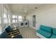 Bright and airy laundry room with washer, dryer, comfortable seating, and lots of natural light at 109 Maple Ave, Anna Maria, FL 34216