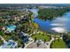 Beautiful aerial view of the community's pool, playground, lake, and surrounding homes at 12682 Shimmering Oak Cir, Venice, FL 34293
