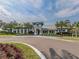 Stunning clubhouse featuring palm trees and blue shutters at 12682 Shimmering Oak Cir, Venice, FL 34293