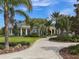 Elegant community clubhouse with manicured landscaping and a welcoming walkway at 12682 Shimmering Oak Cir, Venice, FL 34293