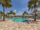Beautiful community pool area with plenty of seating surrounded by lush green landscaping at 12682 Shimmering Oak Cir, Venice, FL 34293
