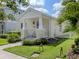 Charming single-story home with a manicured lawn, a quaint front porch, and beautiful curb appeal at 12682 Shimmering Oak Cir, Venice, FL 34293