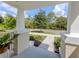 View from front porch of professionally landscaped yard and picturesque street at 12682 Shimmering Oak Cir, Venice, FL 34293