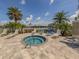 Relaxing hot tub and lounge area with an American flag with lake views at 12682 Shimmering Oak Cir, Venice, FL 34293