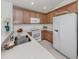 Bright kitchen with white countertops, stainless appliances, and light wood cabinets at 12682 Shimmering Oak Cir, Venice, FL 34293