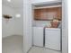Neat laundry room featuring a side-by-side washer and dryer, and upper cabinets for storage at 12682 Shimmering Oak Cir, Venice, FL 34293