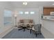 Sun-filled living room with tile flooring, neutral tones, and an open layout for easy entertaining at 12682 Shimmering Oak Cir, Venice, FL 34293