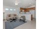 Spacious living area featuring a comfortable sofa and an open layout leading to the kitchen and dining areas at 12682 Shimmering Oak Cir, Venice, FL 34293