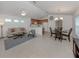 Open-concept living space showcasing a well-lit living room, dining area, and kitchen with modern finishes at 12682 Shimmering Oak Cir, Venice, FL 34293