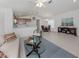 Open-concept living space showcasing a well-lit living room, dining area, and kitchen with modern finishes at 12682 Shimmering Oak Cir, Venice, FL 34293