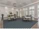 Spacious meeting room featuring stylish tables and chairs on a patterned rug, with bright natural light at 12682 Shimmering Oak Cir, Venice, FL 34293