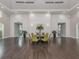 Large meeting room with hardwood floors, shiplap accent walls and a round conference table with seating at 12682 Shimmering Oak Cir, Venice, FL 34293