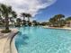 Inviting community pool with crystal-clear water, palm trees, and plenty of space for swimming and relaxation at 12682 Shimmering Oak Cir, Venice, FL 34293
