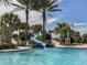 Community pool with a fun water slide and lush tropical landscaping at 12682 Shimmering Oak Cir, Venice, FL 34293