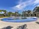 Fun splash pad area with palm tree sprinklers, perfect for to cool off and play at 12682 Shimmering Oak Cir, Venice, FL 34293