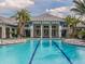 Community swimming pool with clear blue water, featuring a modern design and plenty of lounge space at 12682 Shimmering Oak Cir, Venice, FL 34293