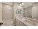 Bathroom includes a bathtub, shower and a double sink vanity with white countertops at 12708 Aquamarine Ave, Bradenton, FL 34211