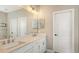 Bathroom featuring a double vanity with modern fixtures and a large mirror at 12708 Aquamarine Ave, Bradenton, FL 34211