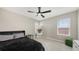 Bright bedroom with a ceiling fan, neutral walls, and a large mirror, offering a cozy and modern space at 12708 Aquamarine Ave, Bradenton, FL 34211