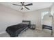 Cozy bedroom features a modern ceiling fan and a full-length mirror, enhancing the room's spacious feel at 12708 Aquamarine Ave, Bradenton, FL 34211