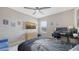 Bedroom features a ceiling fan, a TV, and a desk at 12708 Aquamarine Ave, Bradenton, FL 34211