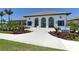Club Indigo exterior showcasing lush landscaping, paved entry and inviting architecture at 12708 Aquamarine Ave, Bradenton, FL 34211