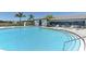 Large community pool with clear blue water and plenty of lounge chairs, perfect for relaxing at 12708 Aquamarine Ave, Bradenton, FL 34211
