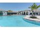 Large community pool with clear water, surrounded by beautiful landscaping and comfortable seating at 12708 Aquamarine Ave, Bradenton, FL 34211