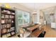 Inviting dining area with a large wooden table and chairs next to a full bookshelf at 12708 Aquamarine Ave, Bradenton, FL 34211