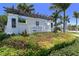 Welcome to Indigo! The community entrance is beautifully landscaped with colorful flowers and lush greenery at 12708 Aquamarine Ave, Bradenton, FL 34211