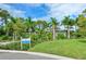 The Indigo Oasis community is beautifully landscaped with lush greenery and tall palm trees at 12708 Aquamarine Ave, Bradenton, FL 34211