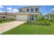Charming two-story home with a well-manicured lawn, shutters, and a two-car garage at 12708 Aquamarine Ave, Bradenton, FL 34211
