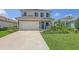 Charming two-story home with a well-manicured lawn, shutters, and a two-car garage at 12708 Aquamarine Ave, Bradenton, FL 34211