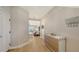 Hallway with modern decor elements, hardwood floors and functional hooks for organization at 12708 Aquamarine Ave, Bradenton, FL 34211
