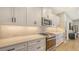 Modern kitchen featuring white cabinets, stainless steel appliances, and a spacious countertop at 12708 Aquamarine Ave, Bradenton, FL 34211