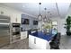 Modern community kitchen with blue countertops, stainless steel appliances, and barstool seating at 12708 Aquamarine Ave, Bradenton, FL 34211