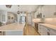Bright kitchen featuring white cabinets, stainless steel appliances, and a spacious quartz countertop island at 12708 Aquamarine Ave, Bradenton, FL 34211