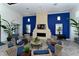 Beautiful community lounge area featuring modern blue accents, herringbone floors, and a cozy fireplace at 12708 Aquamarine Ave, Bradenton, FL 34211