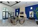 Beautiful community lounge area featuring modern blue accents, herringbone floors, and a cozy fireplace at 12708 Aquamarine Ave, Bradenton, FL 34211