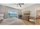 Comfortable main bedroom featuring a king bed, sliding doors to the backyard, and a waterfront view at 12708 Aquamarine Ave, Bradenton, FL 34211
