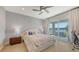 Comfortable main bedroom featuring a king bed, sliding doors to the backyard, and a waterfront view at 12708 Aquamarine Ave, Bradenton, FL 34211