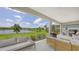 Spacious covered patio with outdoor seating provides beautiful views of the lake at 12708 Aquamarine Ave, Bradenton, FL 34211